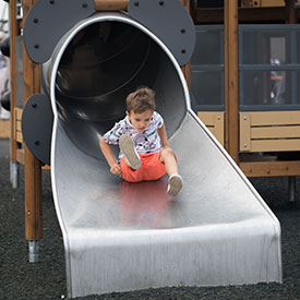 Boy on a tube slide